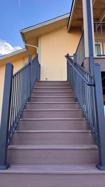 finished custom deck stairs with steel railings in aurora, co build by global cooperation llc