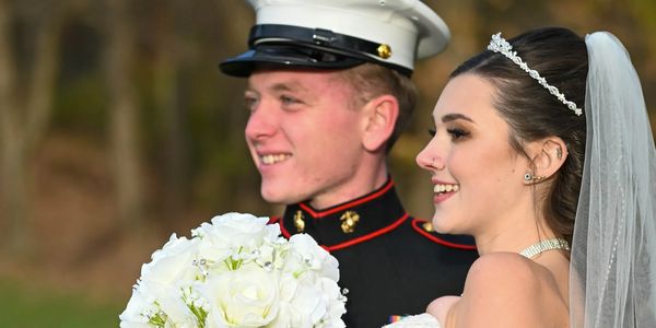 Newly weds posing for a camera.