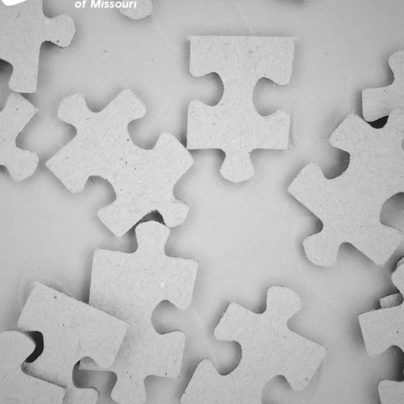 Puzzle pieces scattered on a table, symbolizing parts work in IFS therapy at Safe Harbor Counseling.