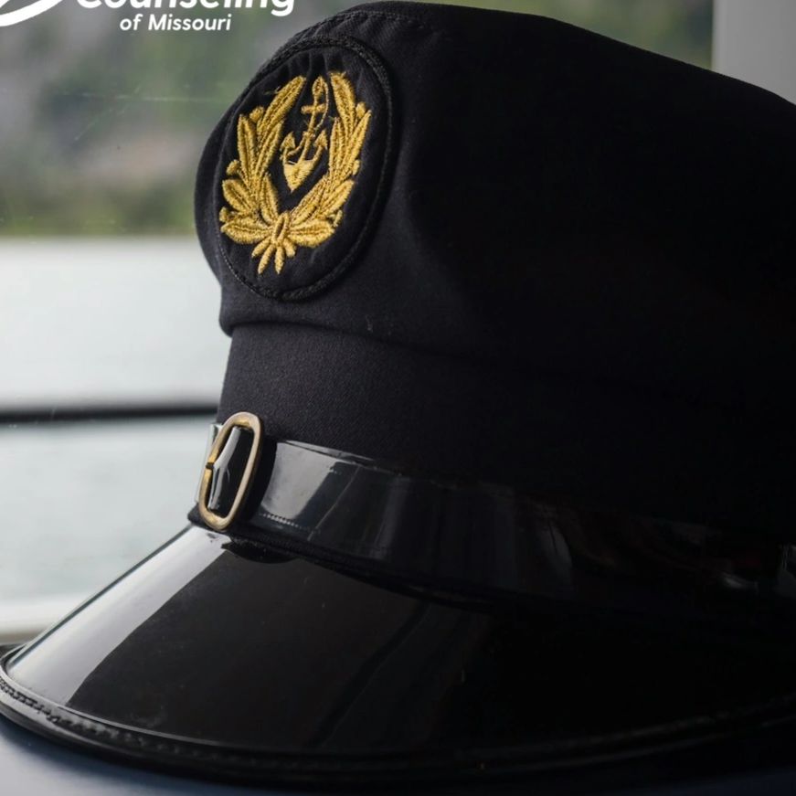 Veteran cap by the window symbolizing trauma-informed therapy at Safe Harbor Counseling MO.
