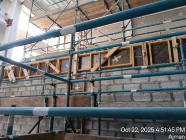 Scaffolding and wooden framework in a construction site inside a building.