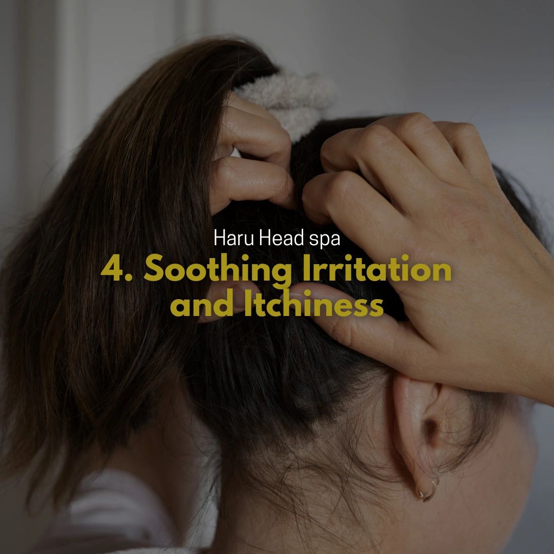 A person with brown hair wearing a hair tie is using both hands to scratch their scalp, illustrating a hair care technique for soothing irritation and itchiness.