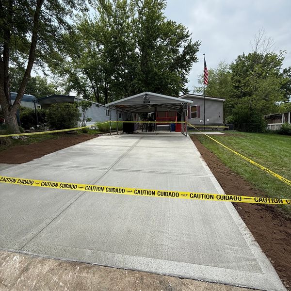 Concrete driveway replacement in Kansas City with clean broom finish. Old driveway removed and new c