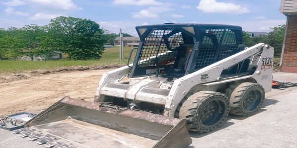 Bobcat work at job site used to prep the site in order to pour concrete for the driveway addition.