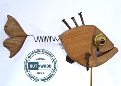 Creative wooden fish sculpture with metal accents and spring tail.