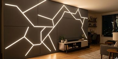 Modern living room with geometric LED wall design and cozy ambiance.