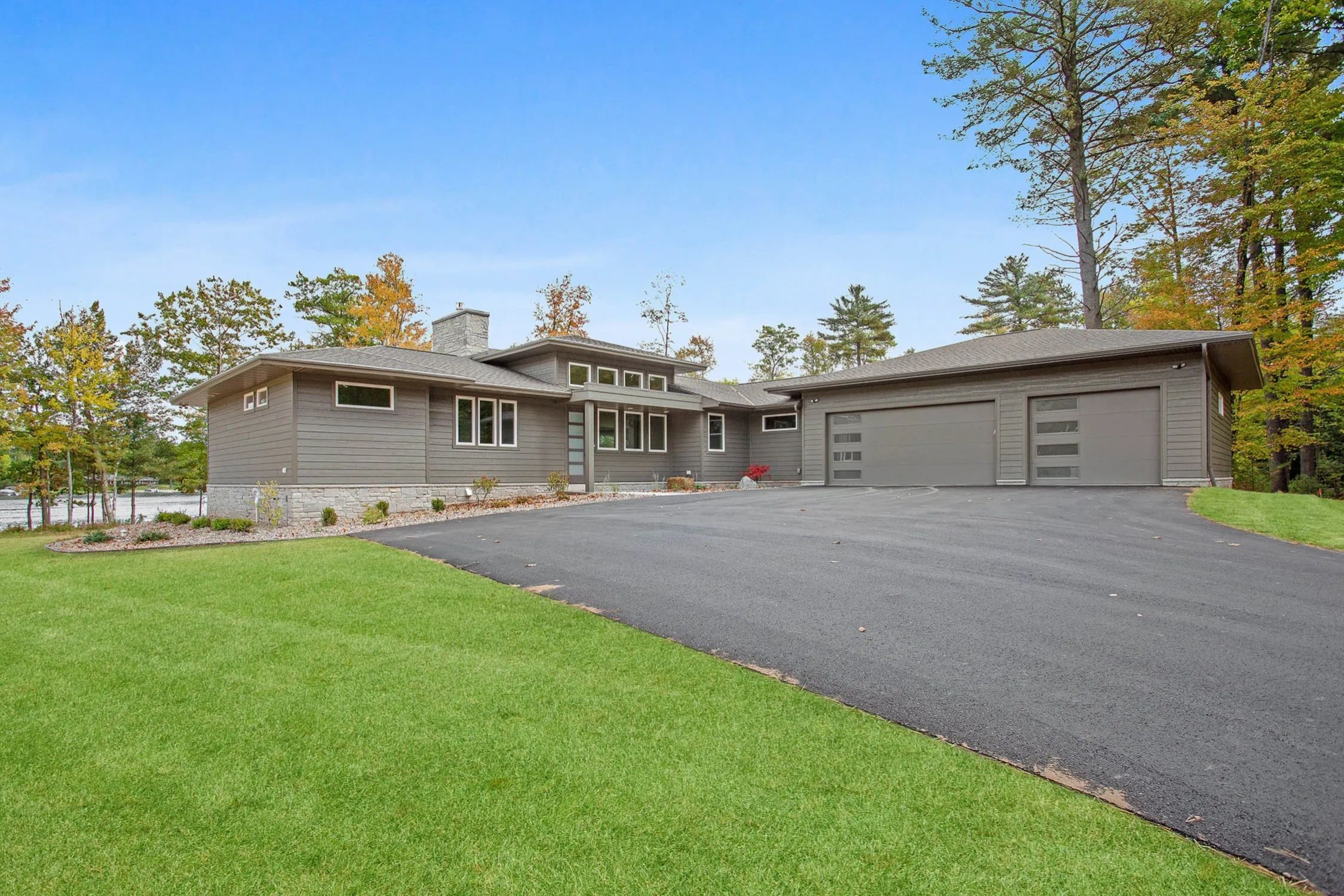 Modern grey house with 3 stall garage and modern window designs