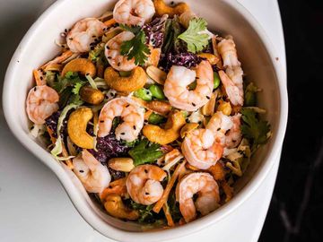 Healthy Asian Salad, including shrimp, organic mix, nappa cabbage, nuts and ginger lemon sauce