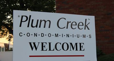Sign welcoming to Plum Creek Condominiums.