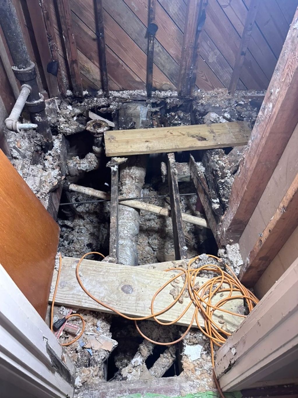 Rot damage in 1970's bathroom floor joist due to shower wall slow leak.
