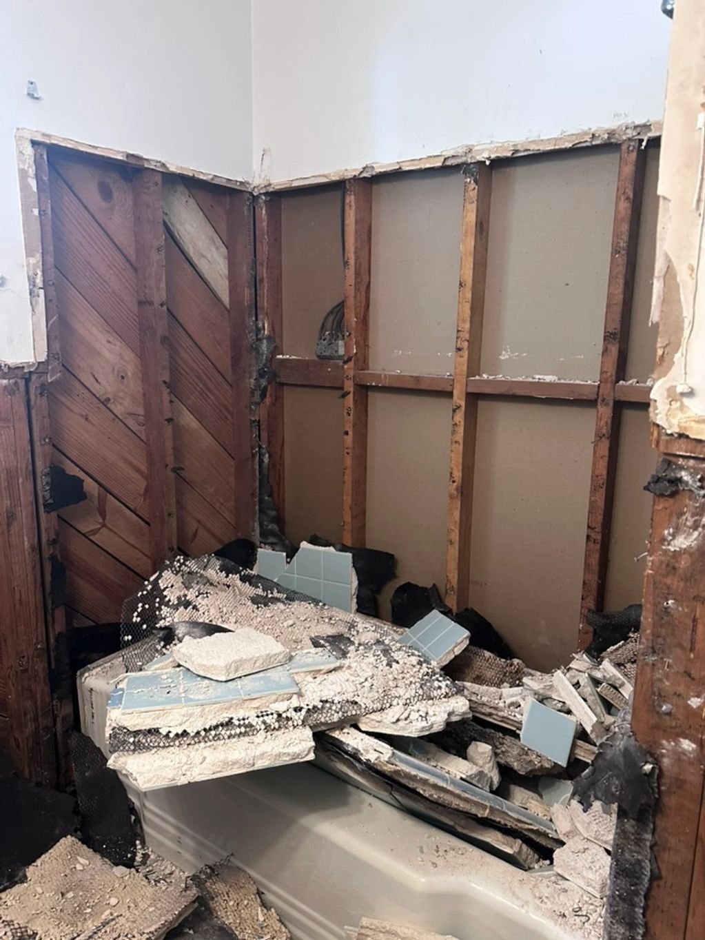 demolition of shower walls with mesh and blue subway tile in Birmingham Alabama