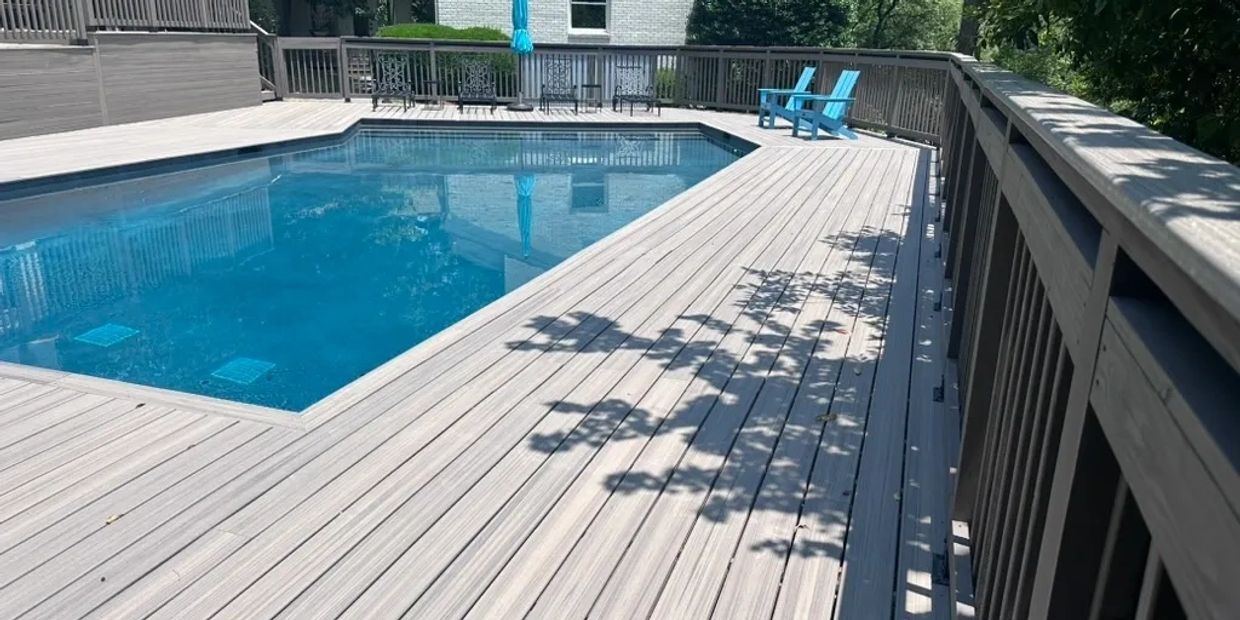 Gray Trex composite deck pool in Hoover Alabama with blue lounge chairs