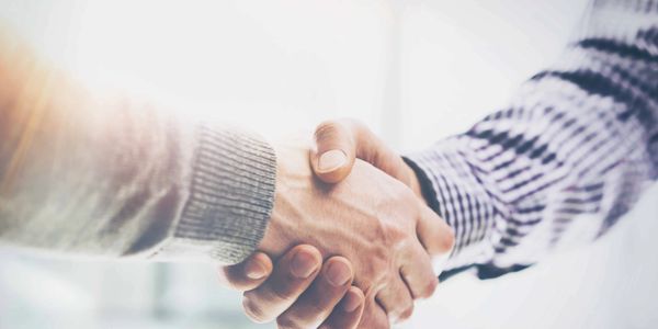 Two people shaking hands with each other