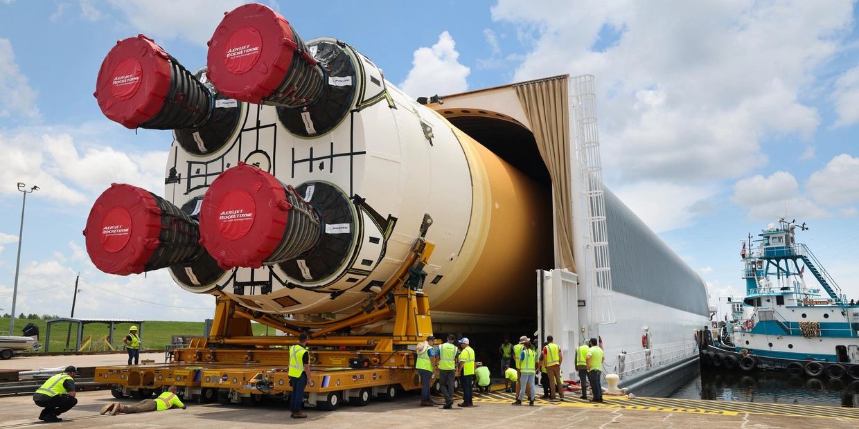 Rocket being transported with workers around.