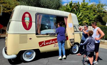 Family buying ice cream from a vintage van.