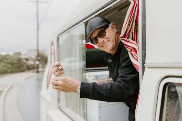 Man serving ice cream from a truck.