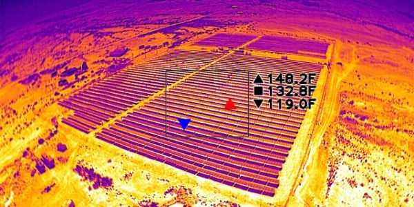 Thermal image of solar panel farm with temperature readings.