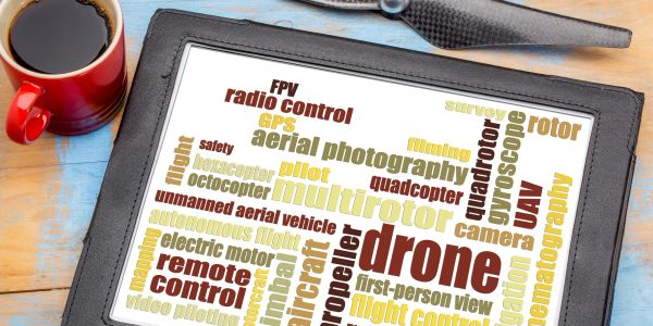 Word cloud of drone-related terms on a tablet screen.