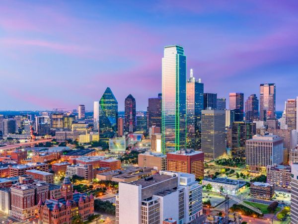 Dallas skyline at dusk with vibrant colored sky.