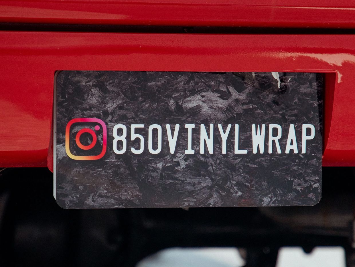Instagram handle 850VINYLWRAP on a textured background.