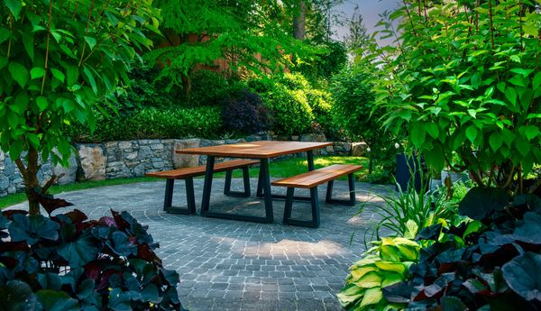 Basalt stone retaining wall, outdoor dining, pergola, lawn area, bluestone stepping stone walkway