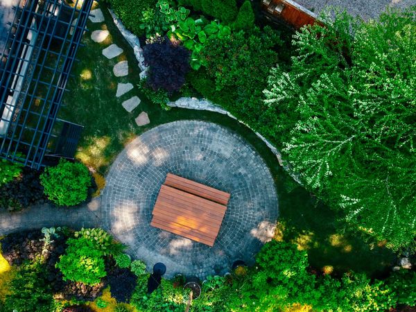 Basalt stone retaining wall, outdoor living, pergola, lawn area, bluestone stepping stone walkway