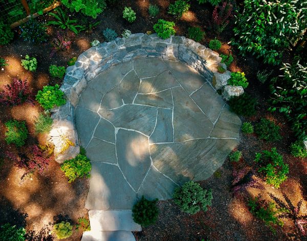 Basalt stone retaining wall and bench, pennsylvania bluestone patio, basalt stone stairs, backyard