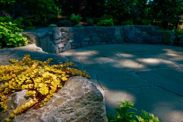 Basalt stone retaining wall and bench, planting details, flagstone patio, elevated back yard