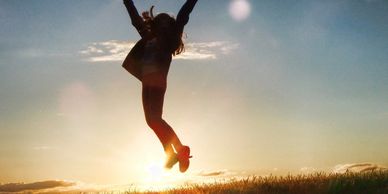 Woman jumping in sunset