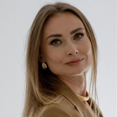 Portrait of a woman with light brown hair and a confident smile.