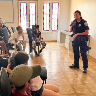 Police officer talking to kids