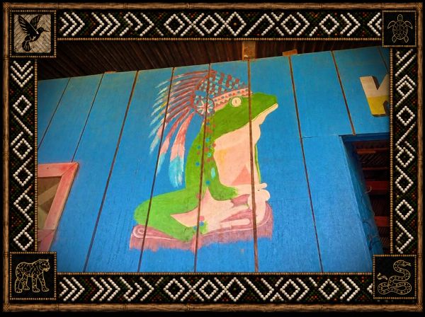 A frog painted on blue wooden planks with tribal border.