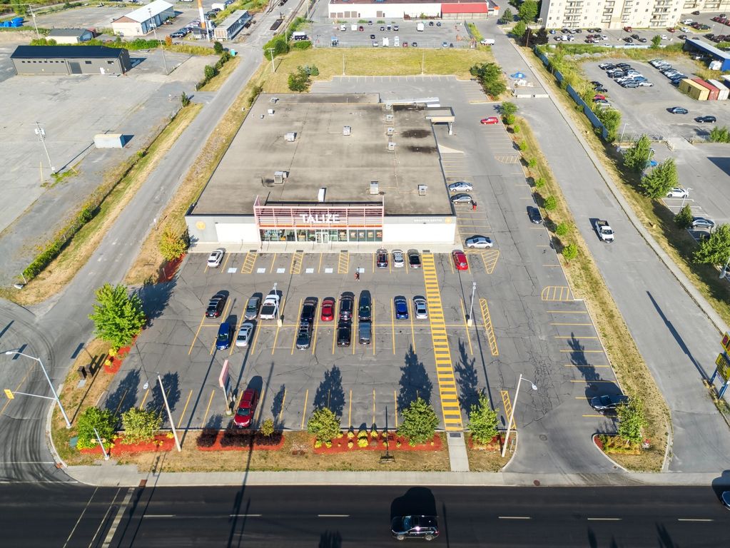 Aerial view of a Talize thrift store with parking lot and cars.