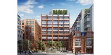 Modern building with rooftop greenery in an urban setting.