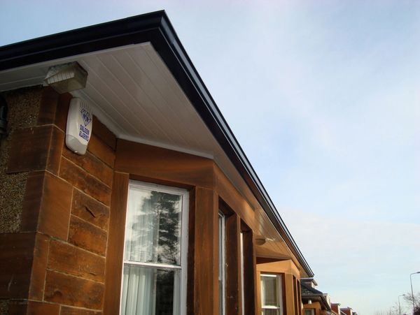 White soffit board and black gutters, looks great, sleek on big bungalow