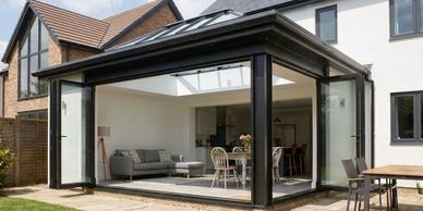 Modern house extension with glass walls and skylight.