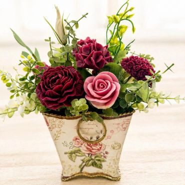 Decorative floral arrangement in a vintage-style pot.