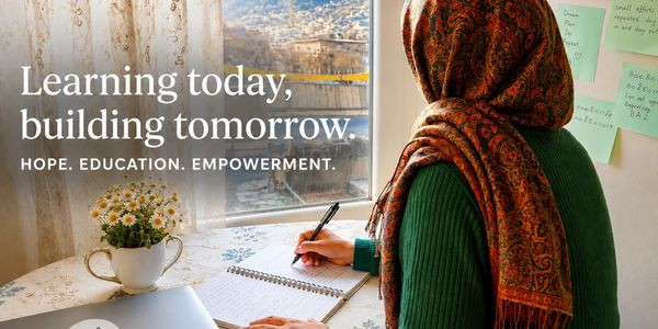 A woman writes in a notebook with a hopeful message about learning and empowerment.