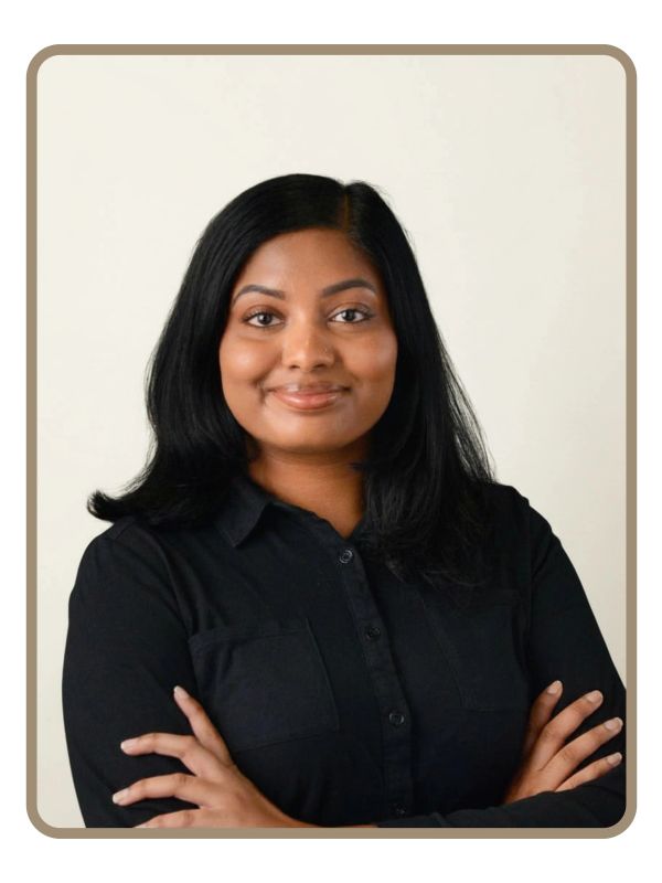 Confident woman with crossed arms and a gentle smile.