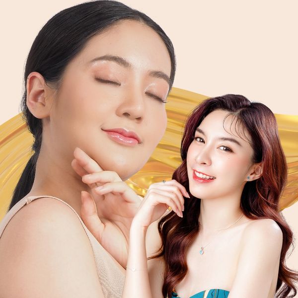 Two women with glowing skin posing against a golden artistic background.