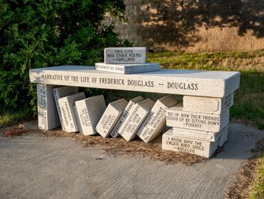 Bench designed like books engraved with quotes from Frederick Douglass.