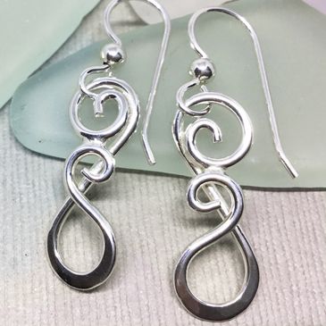 Handcrafted filigree silver swirl hook earrings on handmade in New Hampshire by Ron Cravens.