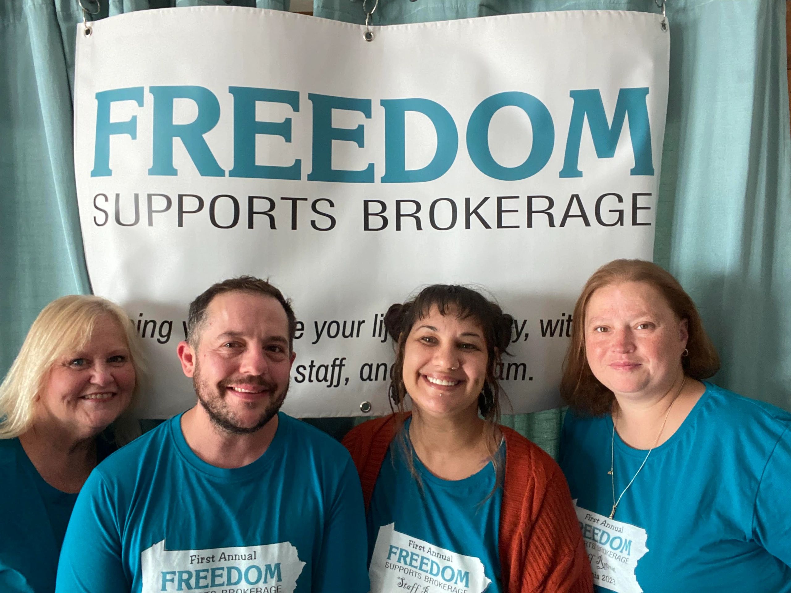 Freedom Supports Brokerage Team pic with FSB banner behind them. 