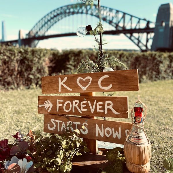 rustic signage with the harbour bridge int the background 