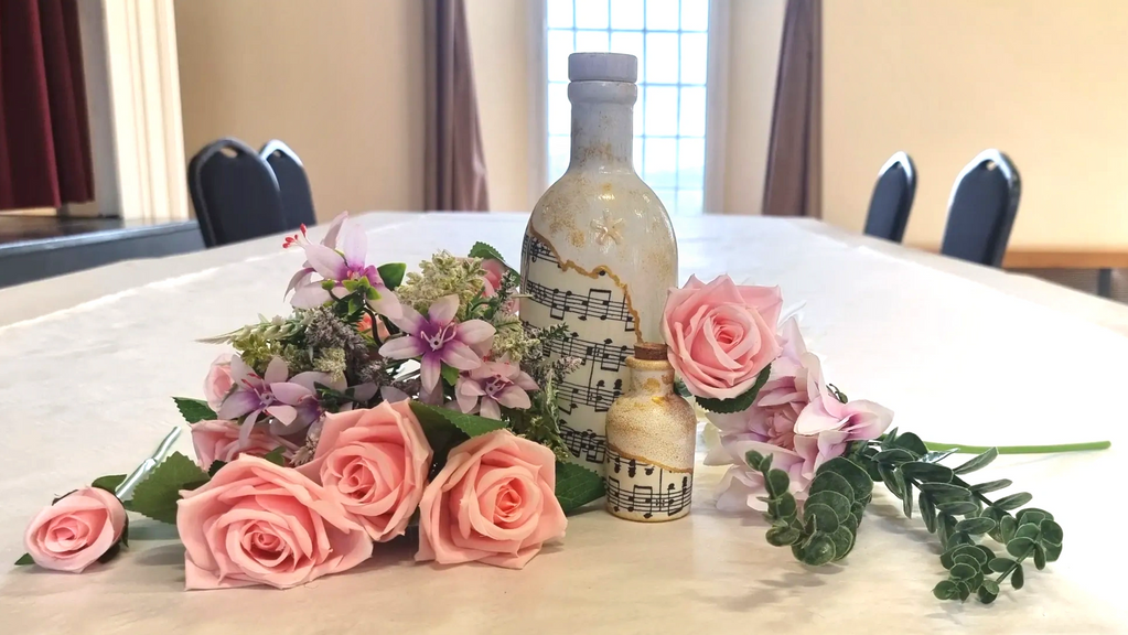 decorative bottle with music notes surrounded by flowers