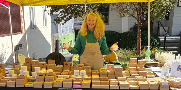 Women-owned farmer small business selling homemade handcrafted natural body products at local market