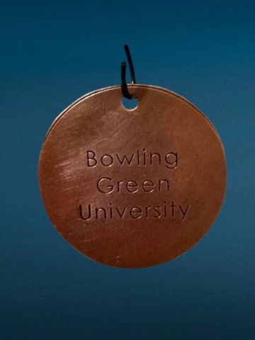 Round copper tag with Bowling Green University text.