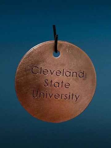 A round tag engraved with Cleveland State University.