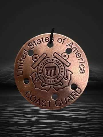 United States Coast Guard emblem on a round metal piece.