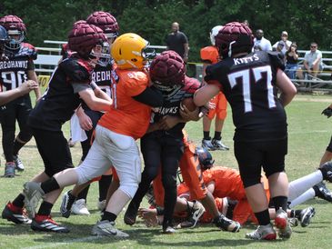 Youth football players in action during a game.